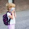 Little girl in mask during corona virus going to school or kindergarten