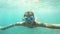 Little girl with mask exploring underwater in the Mediterranean Sea