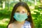 Little girl with mask, pretty girl with medical mask in park