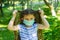 Little girl with mask, pretty girl with medical mask in park