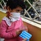 Little Girl in medical mask staying at home under quarantine - stock photo, Isolation Quarantine Corona virus Covid 19