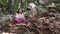 Little girl meditating in the forest