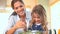 Little girl mixing salad with her mother