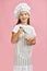 Little girl mixing something with a whisk in bowl.