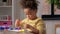 Little girl with modeling clay playing at home