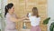 Little Girl with Mom Putting Medical Mask on Toy