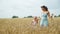 Little Girl with Mom Walking Through Wheat Field