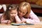 Little girl with mother reading book