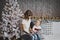 Little girl with mother reading a book sitting under the Christmas tree 7103.