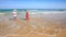 Little Girl Mother in Red Grandpa Play in Foamy Wave Surf