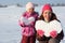 Little girl and mother with snowy hearts