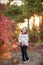 Little girl in a motley autumn park at sunset