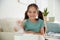 Little girl near air humidifier at home