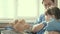 Little girl in office of a pediatrician, plays and treats toy teddy bear and listens to him with stethoscope. male