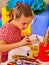 Little girl painting child picture on desk