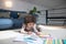 Little girl painting lying on floor in home