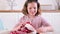 A little girl paints eggs for Easter. Child schoolboy of European appearance and Easter eggs, decor on the table. Light