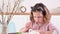 A little girl paints eggs for Easter. Child schoolboy of European appearance and Easter eggs, decor on the table. Light