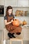 Little girl paints a pumpkin for Halloween. preparation for halloween. Halloween holiday and family lifestyle background.