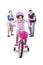 Little girl pedaling bicycle with family