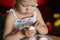 Little girl peeling cooked egg with concentration