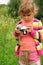 Little girl with photo camera outdoor