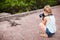 Little girl photographing iguana