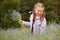 Little girl picking blue flowers