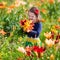 Little girl picking lilly flowers
