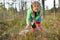 Little girl picking wild cranberries