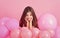 Little girl in pink balloons. Small girl child with party balloons, celebration. Birthday, happiness, childhood, look