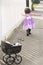 Little girl in pink dress chasing soap bubbles