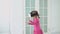 Little girl in pink dress plays in virtual glasses