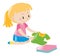 Little girl in pink folding clothes