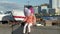 Little girl in a pink hat with a balloon in the river port, dines,