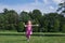 Little Girl in Pink Outfit Catching Bubbles