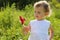 Little girl with pinwheel standing in grass