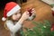 Little girl placing red heart in the christmas tree