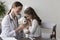 Little girl play otolaryngologist during her visit in clinic