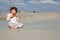 Little girl play panpipe in desert