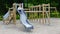 Little girl on a playground. Child playing outdoors in summer. Kids play on school yard.