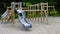 Little girl on a playground. Child playing outdoors in summer. Kids play on school yard.