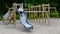 Little girl on a playground. Child playing outdoors in summer. Kids play on school yard.