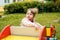 Little girl on the playground. Happy smiling child playing on outdoor.Baby laughs, shouts emotionally, joy and a happy childhood