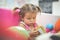 Little girl in playground. Little girl reading picture book.