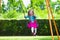 Little girl on playground swing