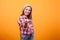 Little girl playin with toy plane in studio on yellow background