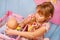 Little girl playing with baby doll