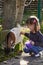 Little girl playing with a baby goat. Children outdoor activities pet care. Child familiarizing herself with animals