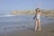 A little girl is playing on the beach.